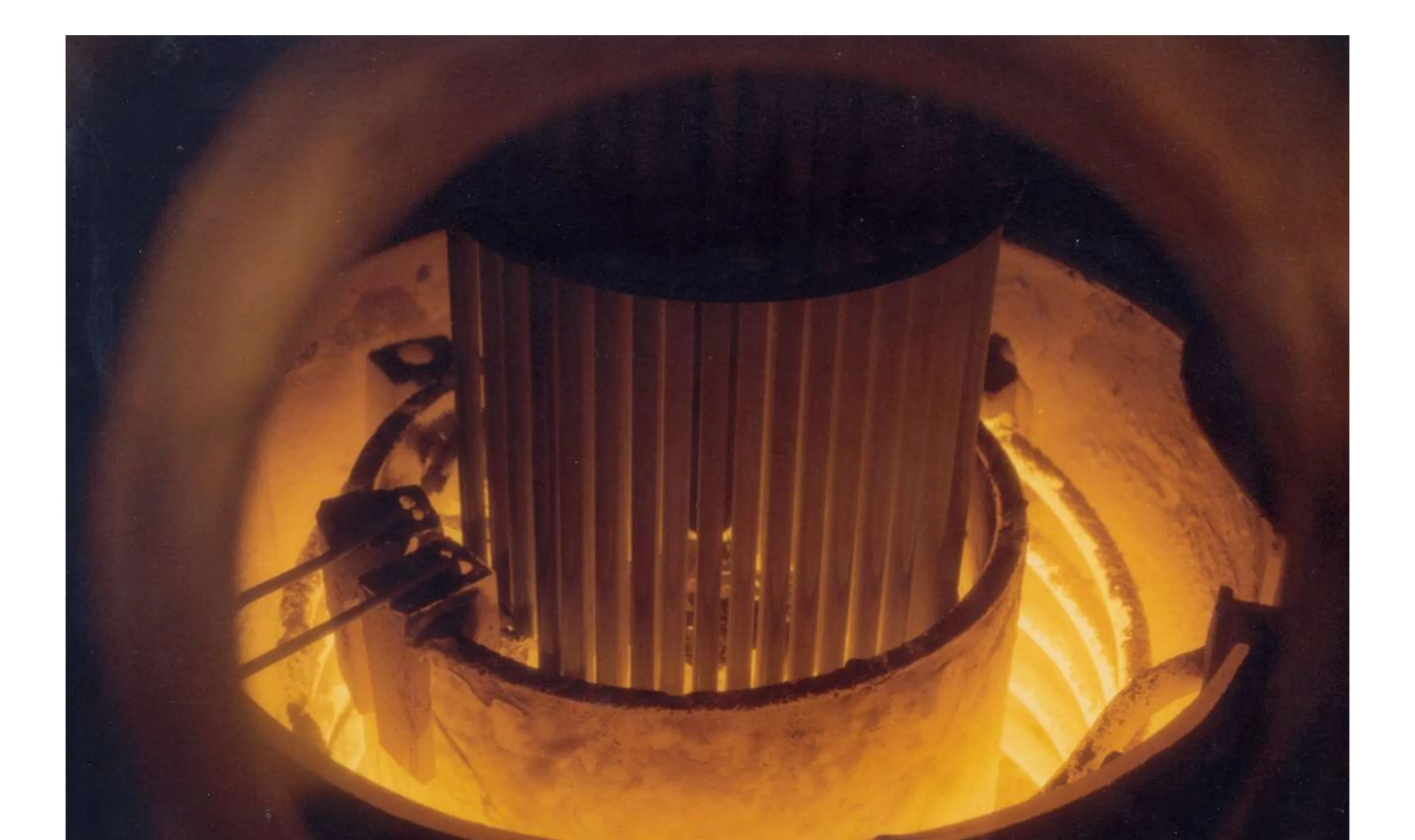 Injection casting fabrication — molten metal fuel rods being cast at Argonne National Laboratory